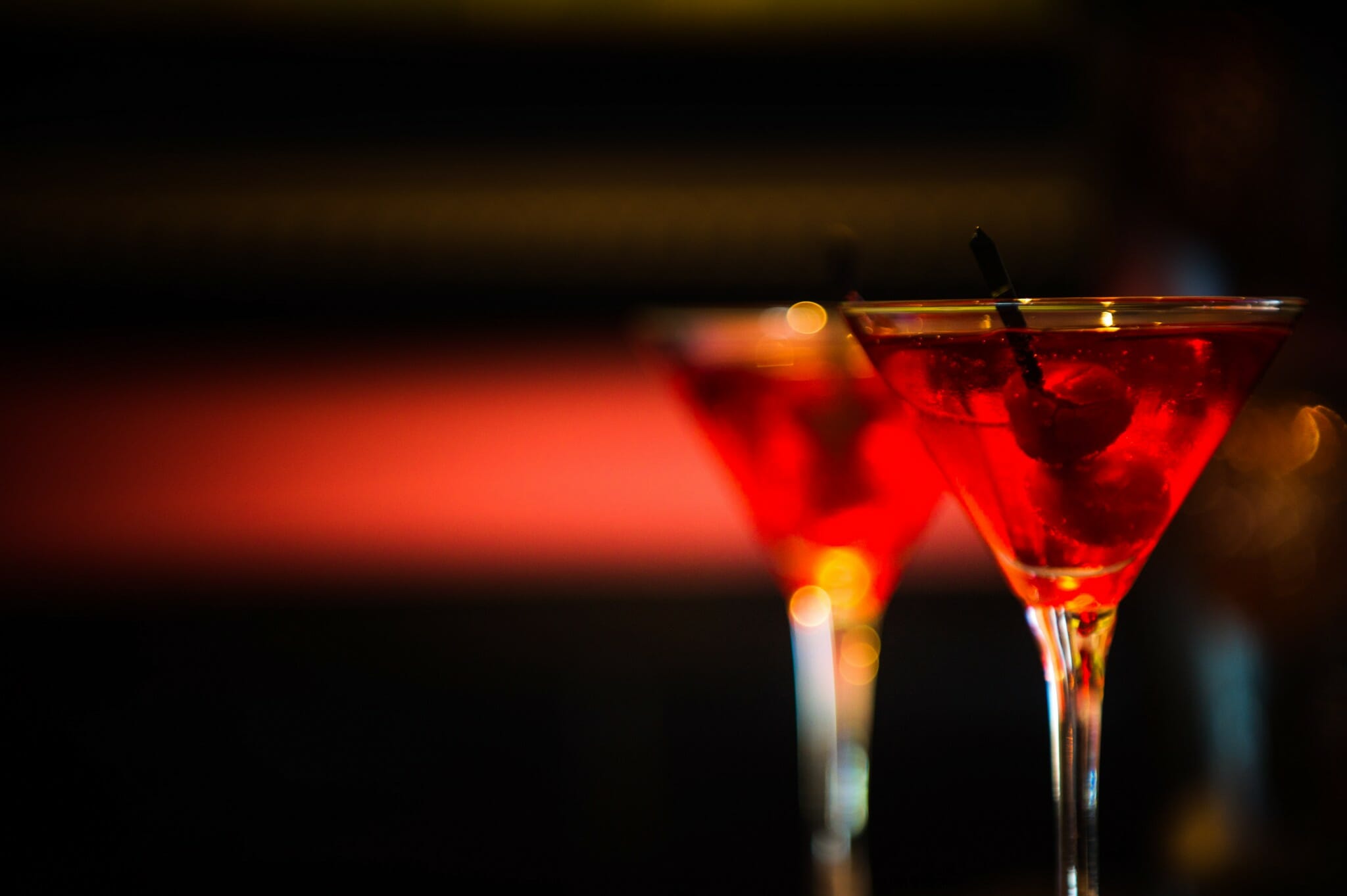 Two martini glasses with red colored liquor