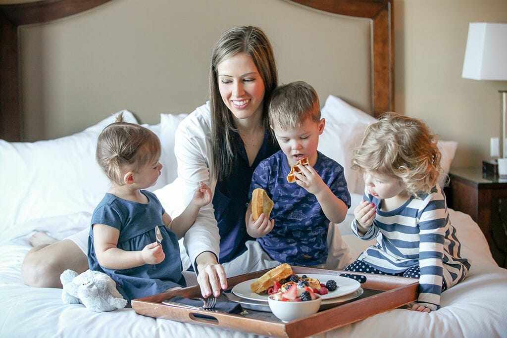 Family Eating Breakfast In Bed