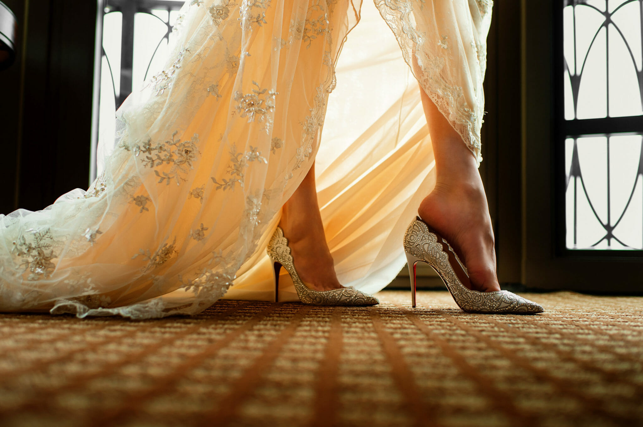 Woman in wedding dress puts on high heels